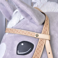 Close-up of Hobby Horse LarDen’s Western Bridle Classic: a light gray plush horse head with black stitched eyes, white details, tan patterned Western bridle, visible fabric texture, and braided mane.