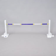 The Hobby Horse LarDen Jump 50 cm / 20 inch is a white adjustable jump stand with a blue, yellow, and white pole—ideal for indoor or outdoor hobby horsing—shown against a plain gray background.