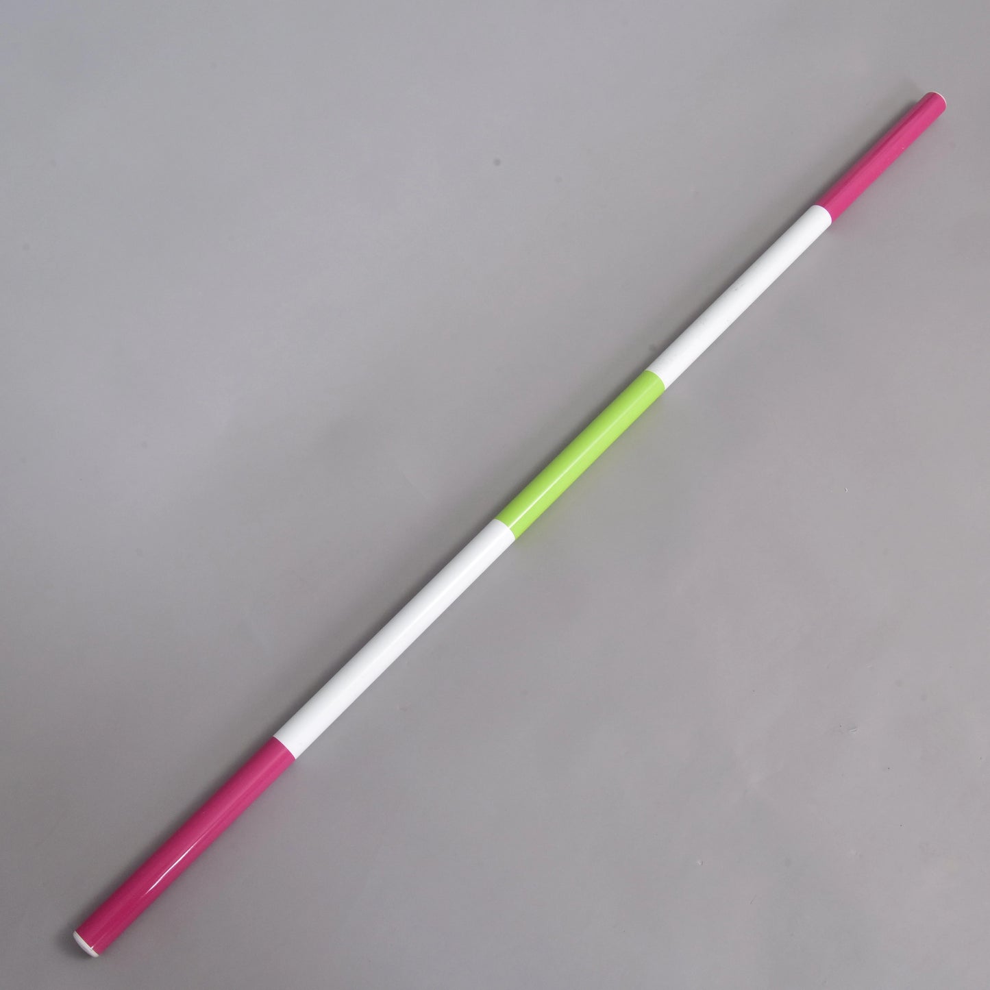 The Hobby Horse LarDen Jump pole pink-green, a lightweight 32 mm diameter pole with alternating pink, white, and a single green section, is shown diagonally on a plain gray background.