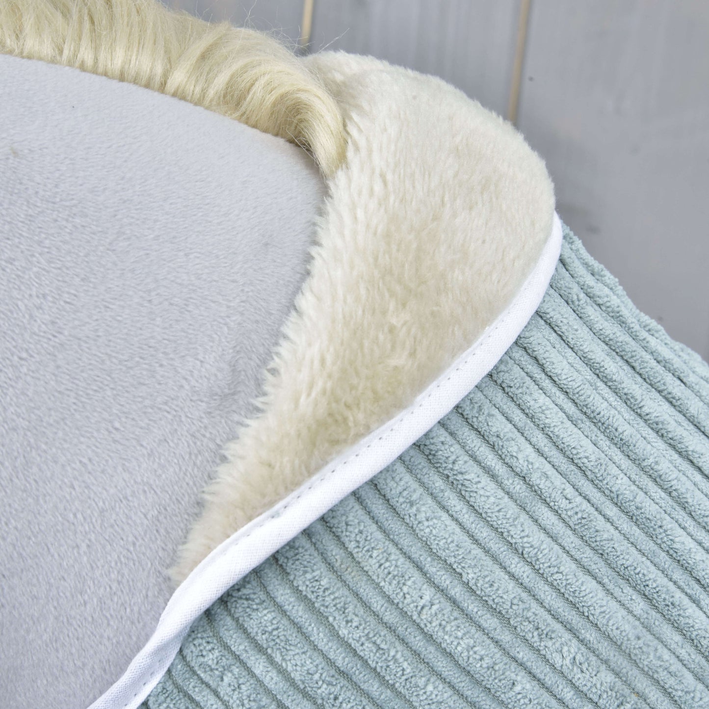Close-up of Set Manchester Little Green by Hobby Horse LarDen: light blue corduroy with white faux fur trim and cream edges—ideal for cozying up after crafting your next Hobby Horse.