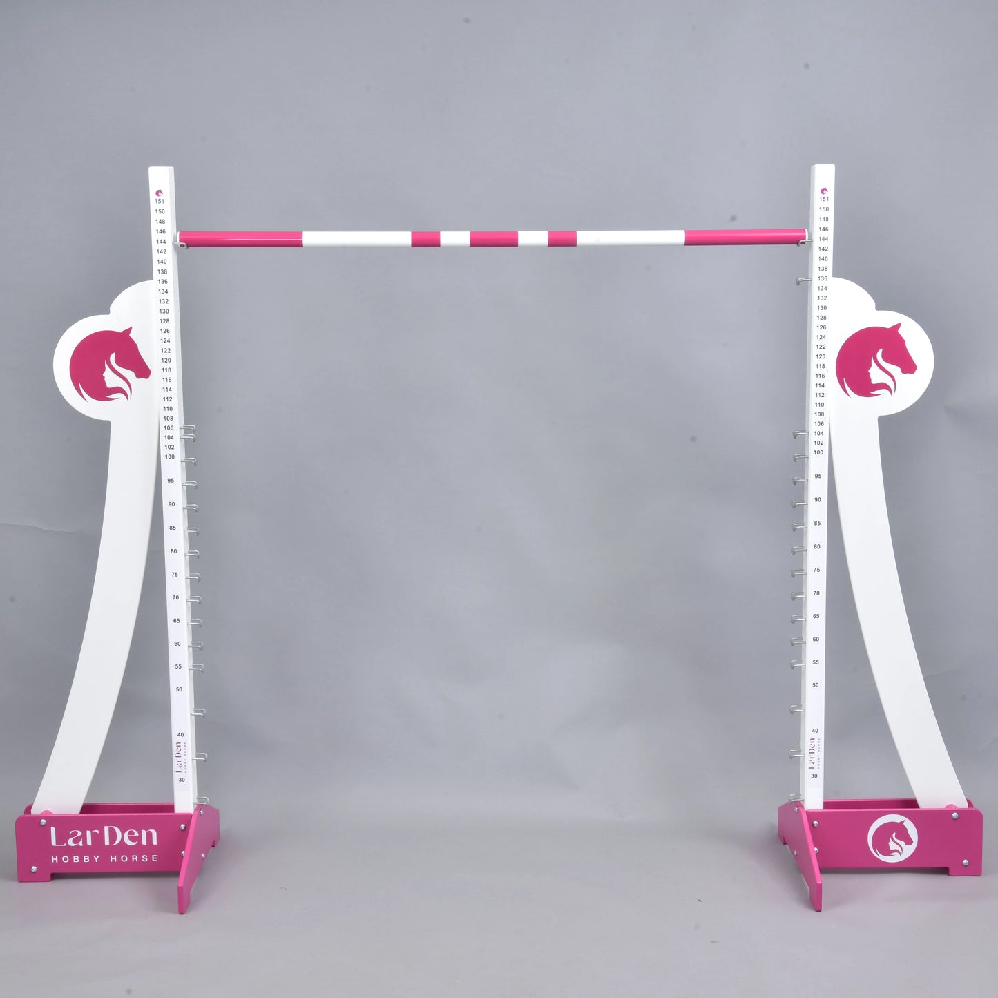 LarDen Hobby Horse Puissance Jump van Hobby Horse LarDen in roze en wit, met paardenhoofdsilhouetten en een gestreepte balk, tegen een effen grijze achtergrond, ideaal voor Hobby Horse Puissance-training.