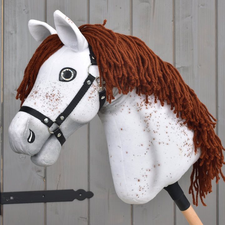 LarDen Hobby Horse Rufus with Black Halter, white speckled Appaloosa with a red-brown yarn mane on a wooden stick