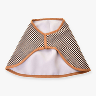 The Blanket english brown plaid double-sided by Hobby Horse LarDen is a small, triangular cape with a geometric brown, black, and white pattern, light brown trim, front closure, and a white inner lining.