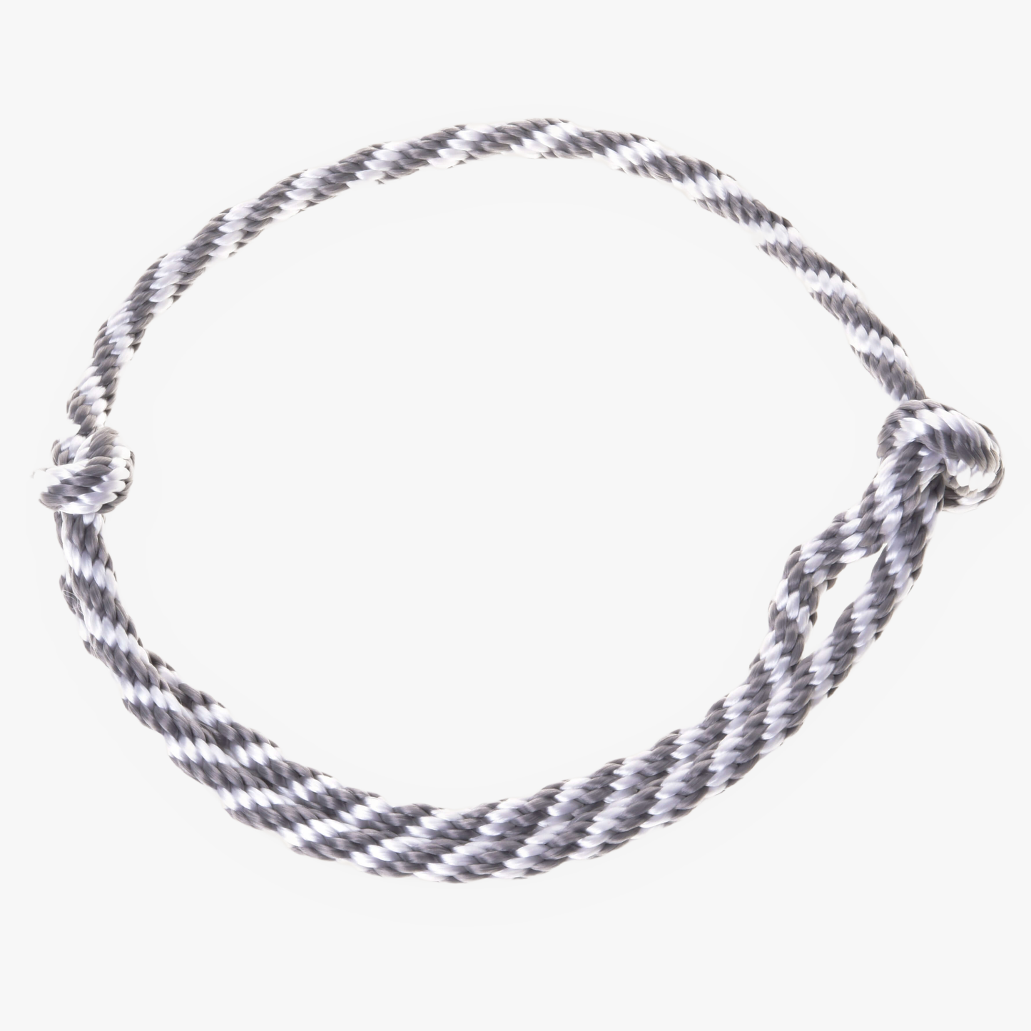 The Cordeo silver stripe by Hobby Horse LarDen features a handmade twisted black and white design, arranged in a circular shape with a simple knot on the right, displayed against a white background.